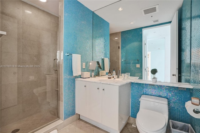 100 S Pointe Dr Unit 3102, Miami Beach, FL 33139 - bathroom with tile walls, a stall shower, toilet, tile patterned floors, and vanity