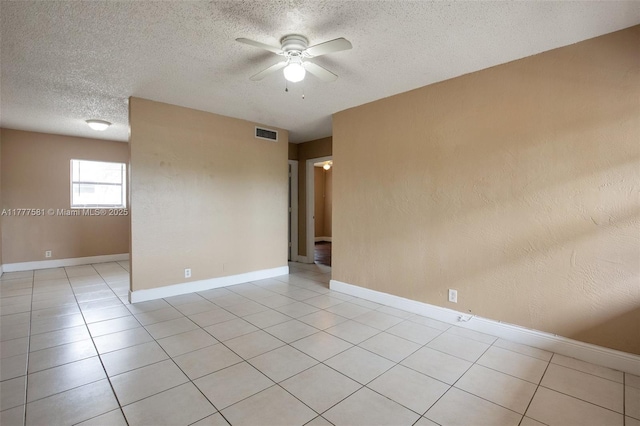 4061 N Dixie Hwy Unit 29, Oakland Park, FL 33334 - empty room with a ceiling fan, a textured ceiling, light tile patterned floors, and baseboards