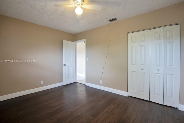 4061 N Dixie Hwy Unit 29, Oakland Park, FL 33334 - unfurnished bedroom with dark wood-type flooring, baseboards, a textured ceiling, a closet, and ceiling fan