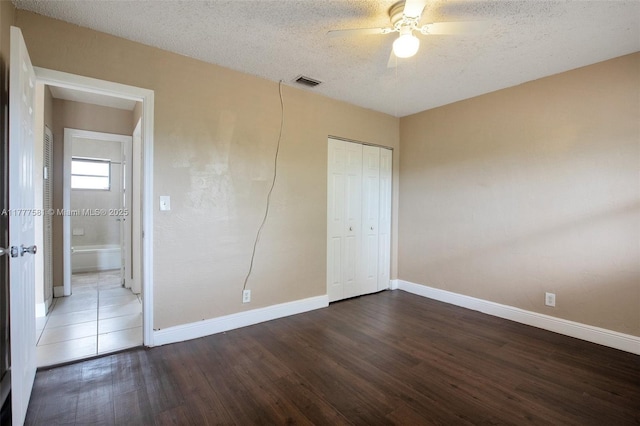 4061 N Dixie Hwy Unit 29, Oakland Park, FL 33334 - unfurnished bedroom featuring wood finished floors, baseboards, a closet, a textured ceiling, and ceiling fan