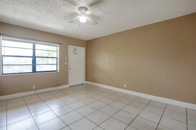 4061 N Dixie Hwy Unit 29, Oakland Park, FL 33334 - unfurnished room with a textured ceiling, a ceiling fan, light tile patterned flooring, and baseboards