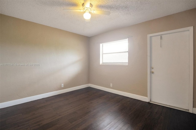 4061 N Dixie Hwy Unit 29, Oakland Park, FL 33334 - unfurnished room with a textured ceiling, dark wood finished floors, a ceiling fan, and baseboards