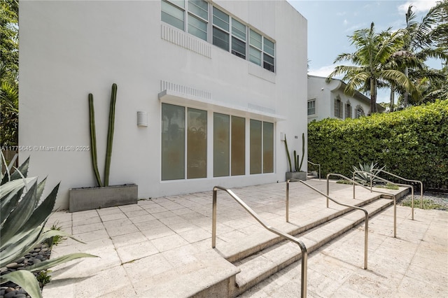 back of property featuring a patio and stucco siding