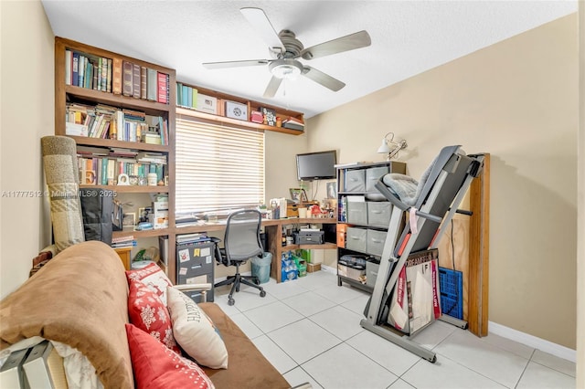 office space with tile patterned floors, ceiling fan, baseboards, and a textured ceiling