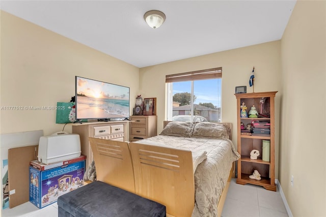 bedroom featuring baseboards and light tile patterned floors