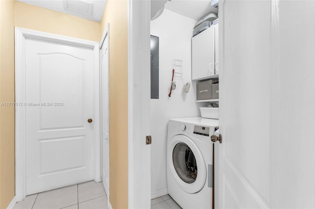 laundry room with visible vents, washer / clothes dryer, cabinet space, and light tile patterned floors