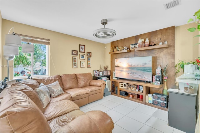living area with tile patterned floors and visible vents