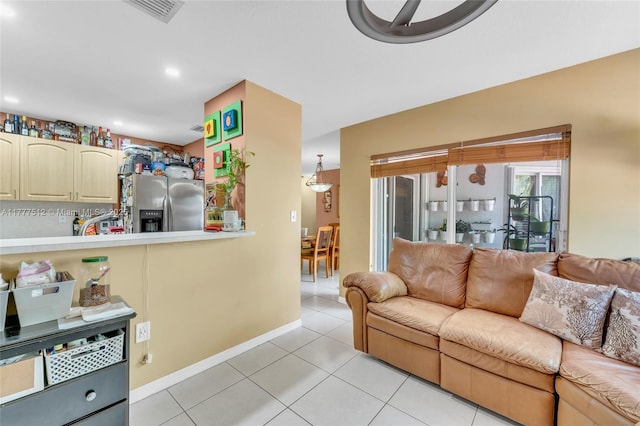 living room featuring baseboards, visible vents, recessed lighting, and light tile patterned floors