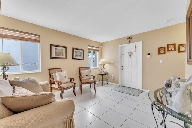 living area with baseboards and light tile patterned floors