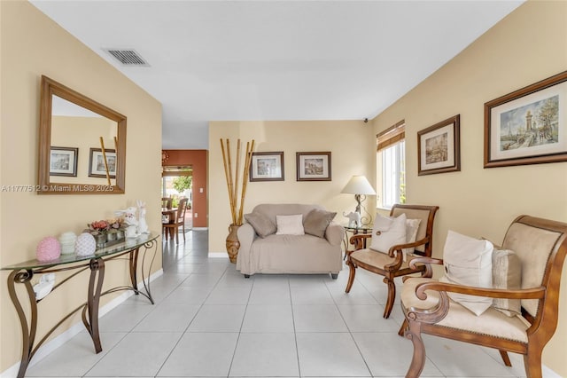 living room with light tile patterned floors, baseboards, and visible vents