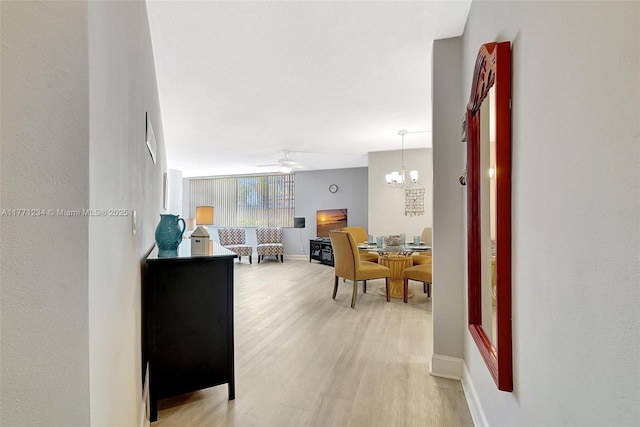 1936 S Ocean Dr Unit 2D, Hallandale Beach, FL 33009 - hall with light wood finished floors, baseboards, and a chandelier