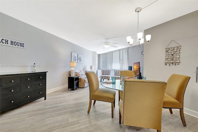 1936 S Ocean Dr Unit 2D, Hallandale Beach, FL 33009 - dining area featuring a chandelier, light wood finished floors, baseboards, and a ceiling fan