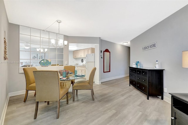 1936 S Ocean Dr Unit 2D, Hallandale Beach, FL 33009 - dining space with baseboards, light wood-style flooring, and a chandelier