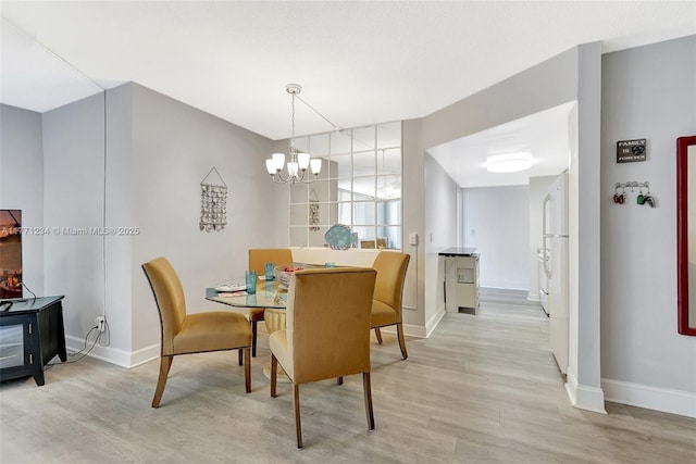 1936 S Ocean Dr Unit 2D, Hallandale Beach, FL 33009 - dining space with a chandelier, light wood finished floors, and baseboards