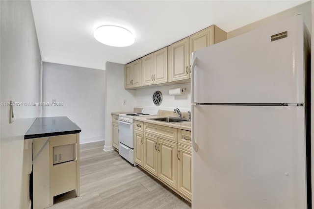 1936 S Ocean Dr Unit 2D, Hallandale Beach, FL 33009 - kitchen with white appliances, a sink, cream cabinets, light wood-type flooring, and baseboards