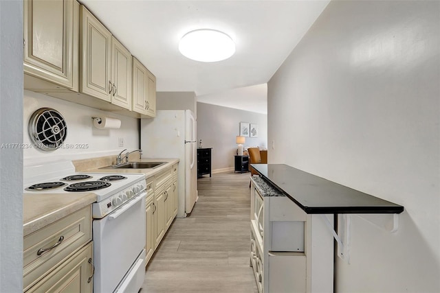 1936 S Ocean Dr Unit 2D, Hallandale Beach, FL 33009 - kitchen featuring white appliances, a sink, cream cabinets, and light wood-style flooring