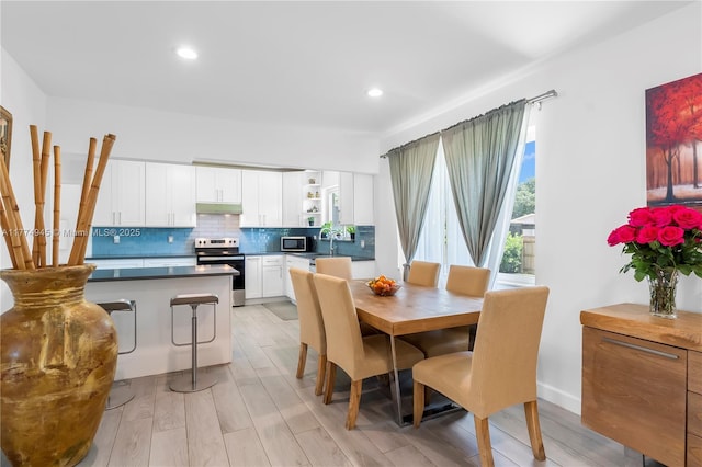 11215 NE 4th Ave, Miami, FL 33161 - dining room featuring light wood-type flooring and recessed lighting