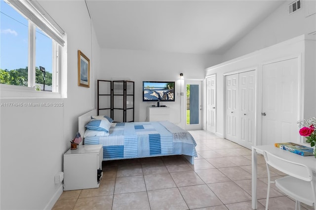11215 NE 4th Ave, Miami, FL 33161 - bedroom featuring multiple windows, lofted ceiling, light tile patterned flooring, and multiple closets