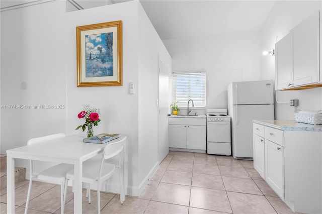 11215 NE 4th Ave, Miami, FL 33161 - kitchen with white appliances, white cabinetry, light tile patterned flooring, and light countertops
