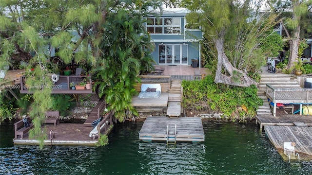 4901 SW 71st Pl Unit 4901, Miami, FL 33155 - back of house with french doors, a deck with water view, and stairway