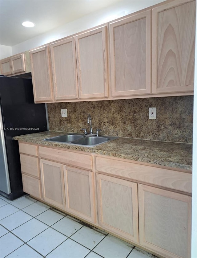 28315 SW 141st Pl Unit 28315, Homestead, FL 33033 - kitchen featuring light brown cabinetry, a sink, light tile patterned floors, freestanding refrigerator, and backsplash