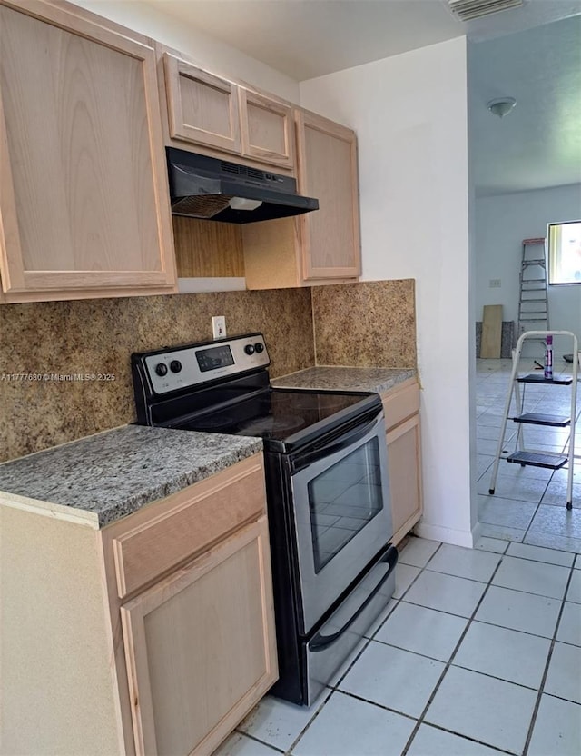28315 SW 141st Pl Unit 28315, Homestead, FL 33033 - kitchen with electric range, under cabinet range hood, light brown cabinets, tasteful backsplash, and light tile patterned flooring