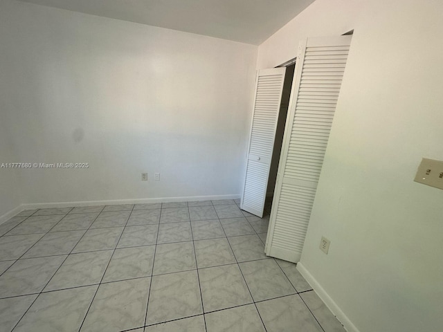 28315 SW 141st Pl Unit 28315, Homestead, FL 33033 - unfurnished bedroom featuring a closet, baseboards, and light tile patterned flooring