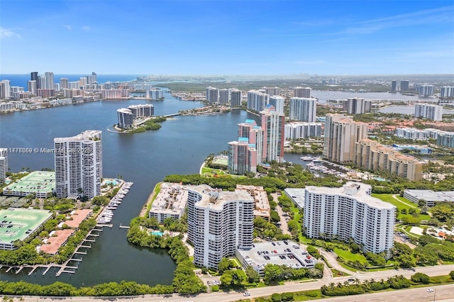 birds eye view of property with a water view and a view of city