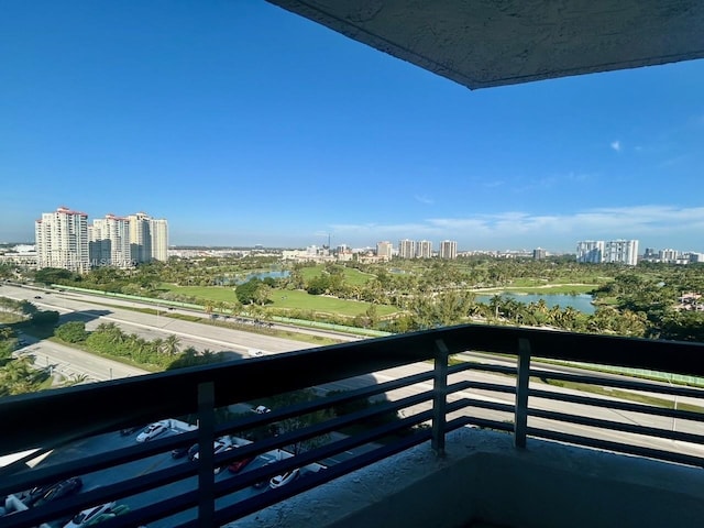 balcony featuring a view of city and a water view