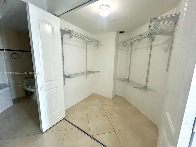 spacious closet featuring light tile patterned floors