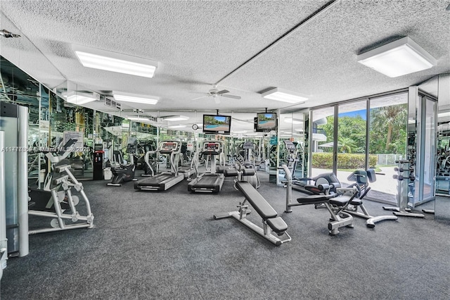 exercise room with ceiling fan, expansive windows, and a textured ceiling