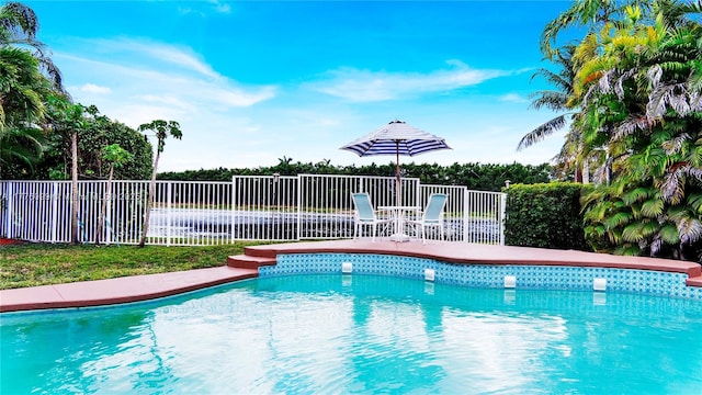 view of swimming pool featuring fence and a fenced in pool