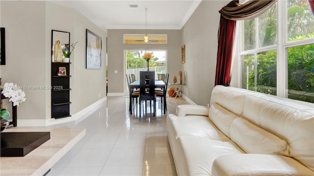 living room with visible vents, ornamental molding, baseboards, and light tile patterned floors