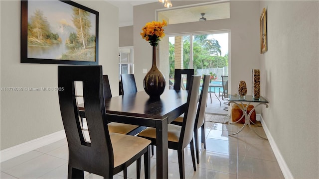 dining area with baseboards and light tile patterned flooring