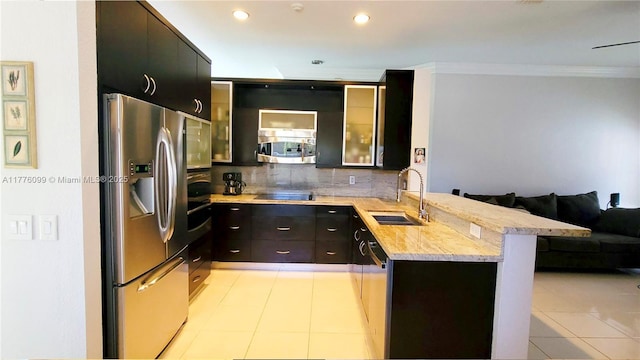 kitchen with stainless steel appliances, a peninsula, a sink, crown molding, and a breakfast bar area