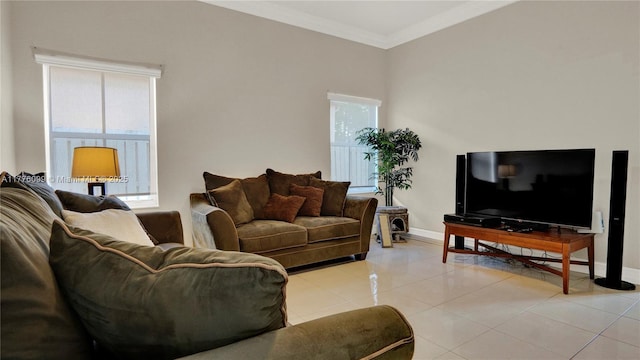 living area with baseboards, ornamental molding, and light tile patterned flooring