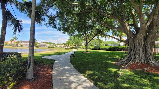 surrounding community featuring a yard, a residential view, and a water view