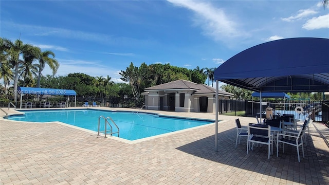 pool featuring fence and a patio
