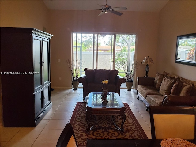 living area featuring light tile patterned flooring and a ceiling fan