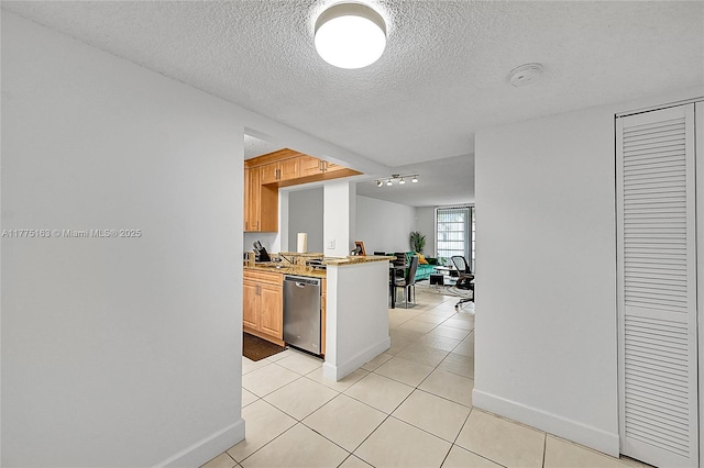 1820 SW 81st Ave Unit 3300, North Lauderdale, FL 33068 - kitchen featuring a textured ceiling, a peninsula, light tile patterned flooring, dishwasher, and baseboards
