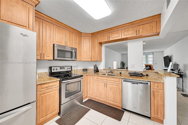 1820 SW 81st Ave Unit 3300, North Lauderdale, FL 33068 - kitchen with a sink, appliances with stainless steel finishes, a peninsula, light stone countertops, and light tile patterned flooring