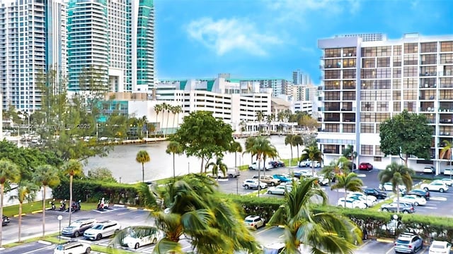 view of building exterior with a city view and uncovered parking