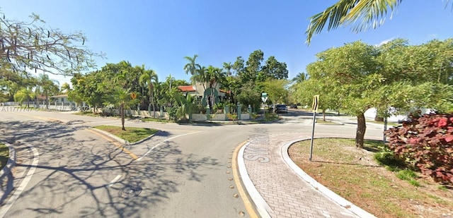 view of street featuring sidewalks, curbs, and traffic signs