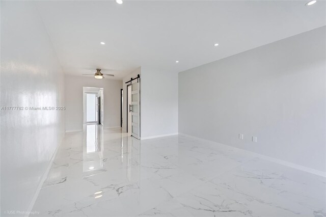 641 Espanola Way Unit 35, Miami Beach, FL 33139 - empty room featuring light marble finish floors, a barn door, baseboards, and recessed lighting
