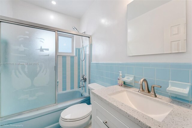641 Espanola Way Unit 35, Miami Beach, FL 33139 - full bath featuring toilet, vanity, enclosed tub / shower combo, tile walls, and wainscoting