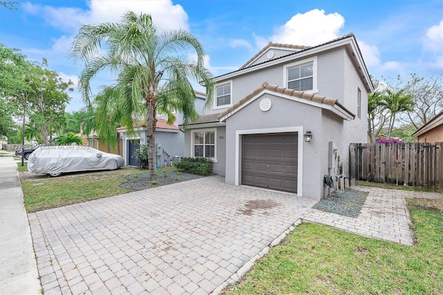 1431 SE 18th Ter, Homestead, FL 33035 - mediterranean / spanish-style home with a tile roof, stucco siding, fence, decorative driveway, and a garage