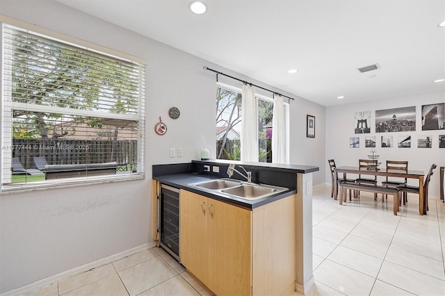 1431 SE 18th Ter, Homestead, FL 33035 - kitchen with a sink, beverage cooler, dark countertops, light tile patterned floors, and visible vents