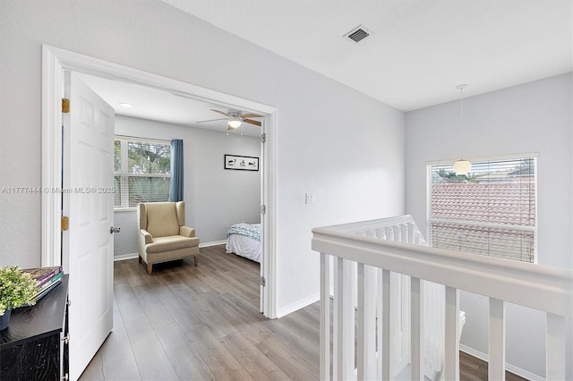 1431 SE 18th Ter, Homestead, FL 33035 - hallway with wood finished floors, an upstairs landing, baseboards, and visible vents