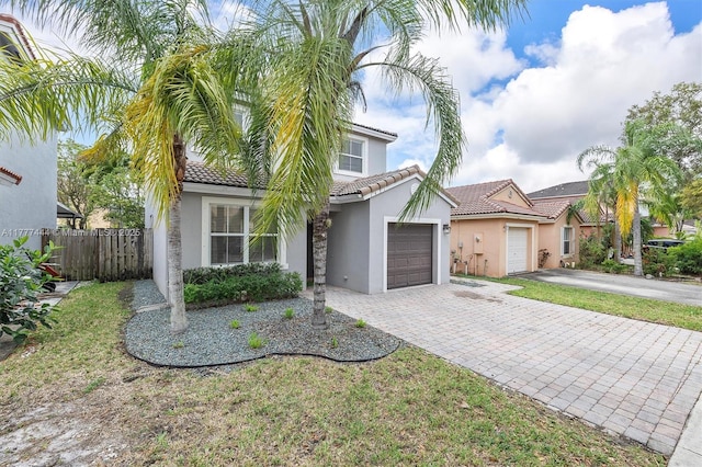 1431 SE 18th Ter, Homestead, FL 33035 - view of front of property featuring a tiled roof, decorative driveway, stucco siding, and an attached garage