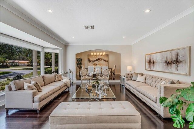 7465 SW 159th Ter, Palmetto Bay, FL 33157 - living room featuring wood finished floors, a notable chandelier, crown molding, and visible vents